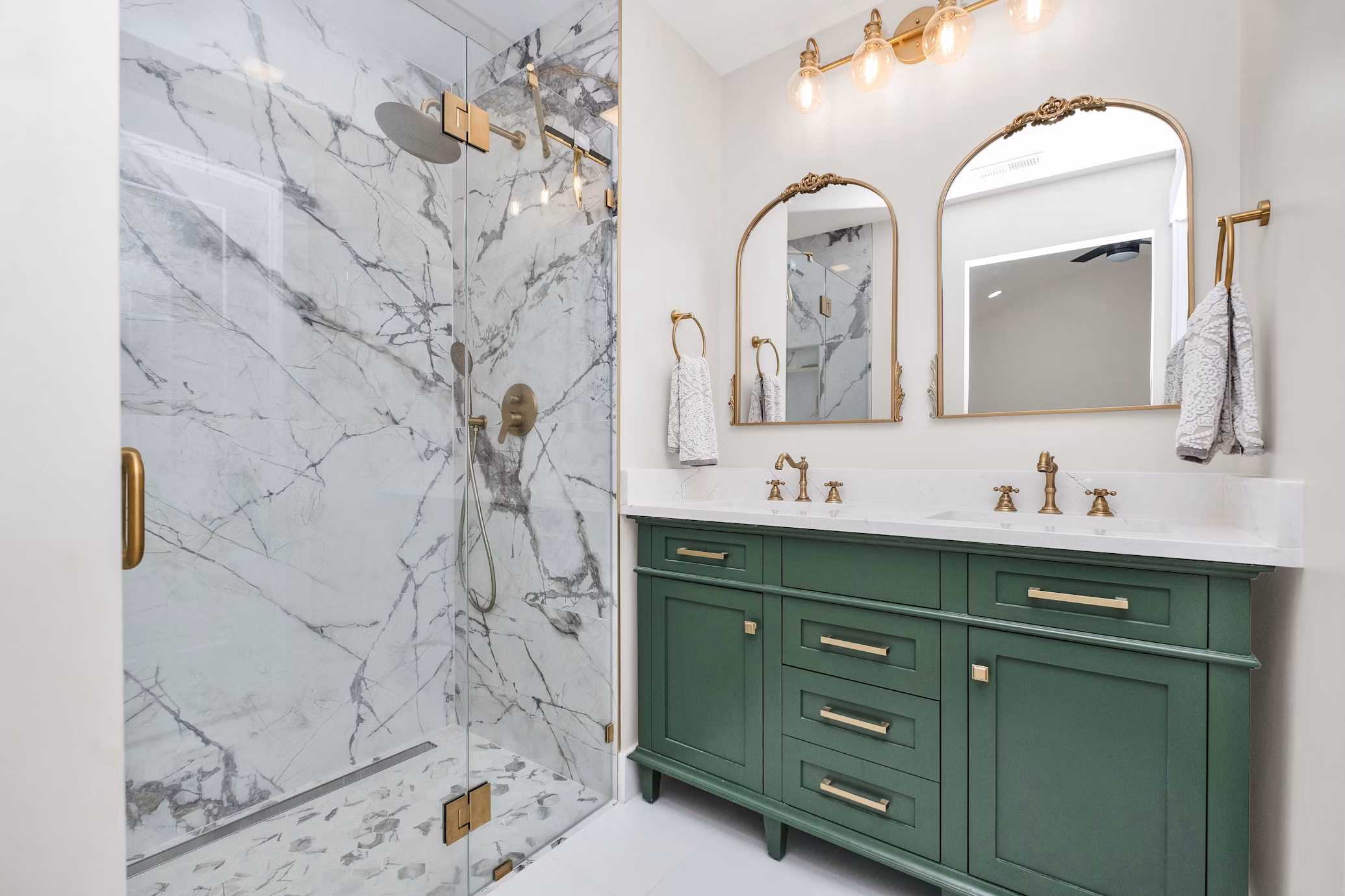 Bathroom with Green Cabinets and Marble Shower